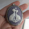 purple and white cat lovers cameo necklace on silver locket.