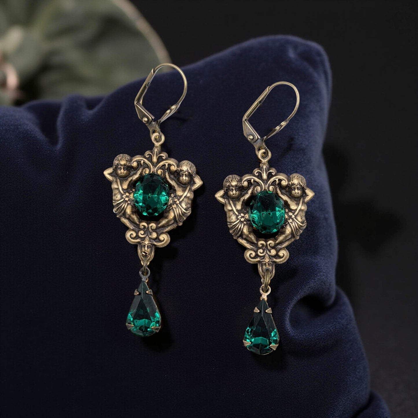 Baroque-inspired earrings with dangling green Swarovski teardrop and antique gold finish