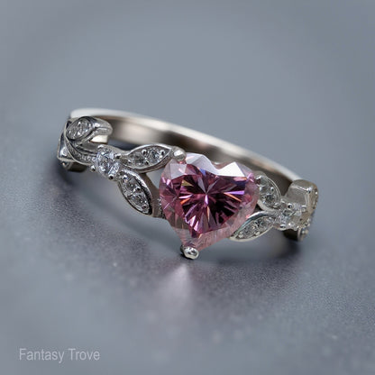 Silver ring with a pink heart-shaped gemstone on a gray background