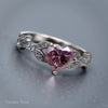 Silver ring with a pink heart-shaped gemstone on a gray background