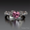 Ring with a pink heart-shaped gemstone on a dark background