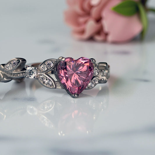 Ring with pink heart-shaped gemstone on a light background
