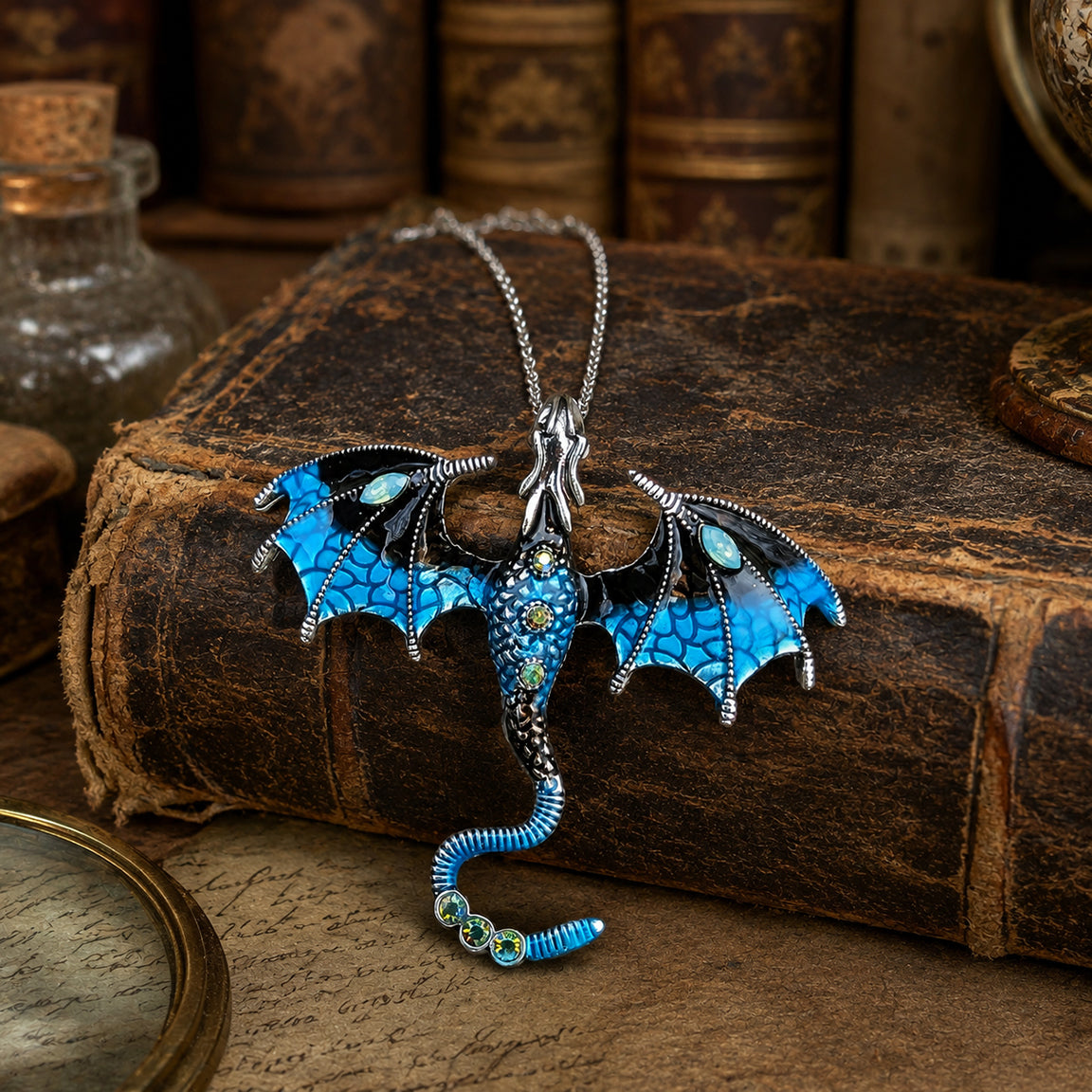 Blue dragon necklace on an old book with a rustic background