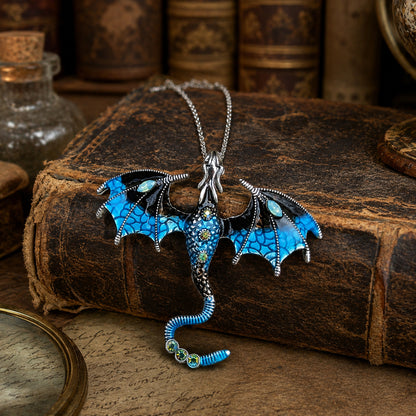 Blue dragon necklace on an old book with a rustic background