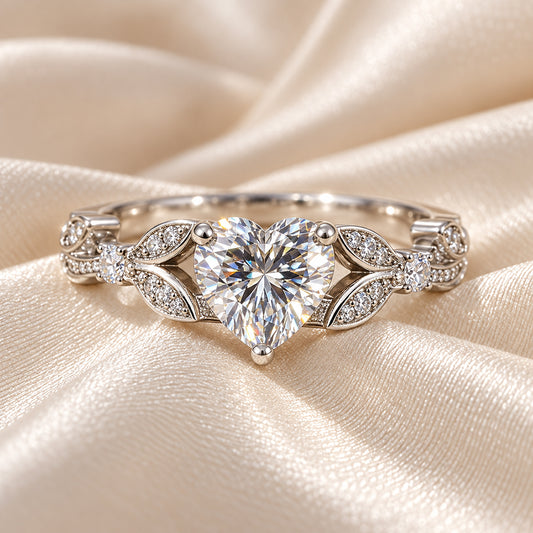 Heart moissanite promise engagement ring with floral detail and white gold plated sterling silver core.