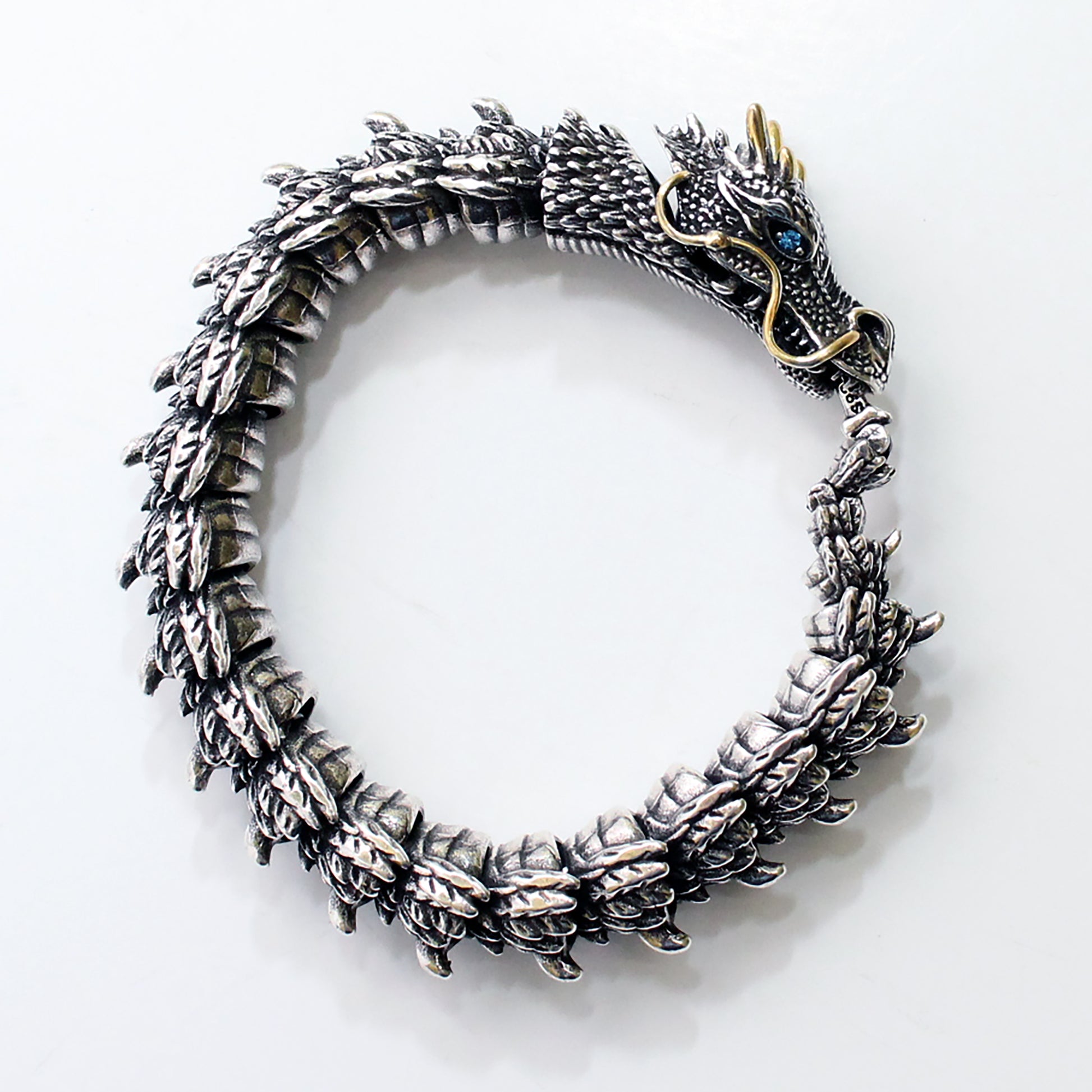 Silver dragon bracelet on a white background