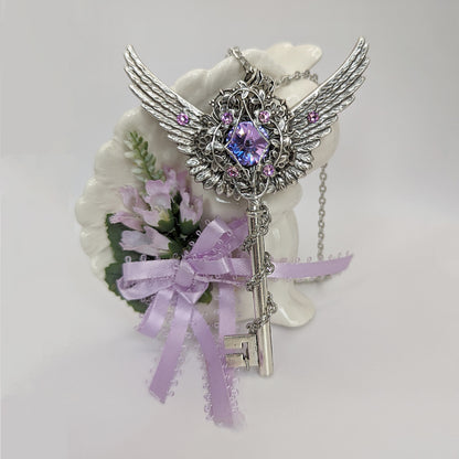 Fantasy floral sterling silver key necklace with wings made with Swarovski crystals.  Fairy jewelry.