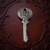 Decorative key with 'LIFE' engraved on it against a dark, ornate background
