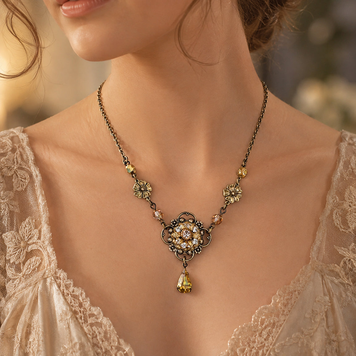 A close-up lifestyle shot of a woman wearing an ornate antique-style brass necklace with gold crystal and flower accents and a dangling yellow crystal pendant.