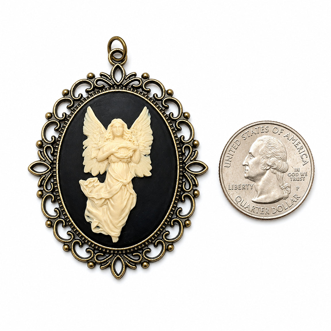 Decorative vintage angel cameo pendant necklace with intricate gold frame next to a U.S. quarter dollar coin on a white background.  Victorian spiritual jewelry.