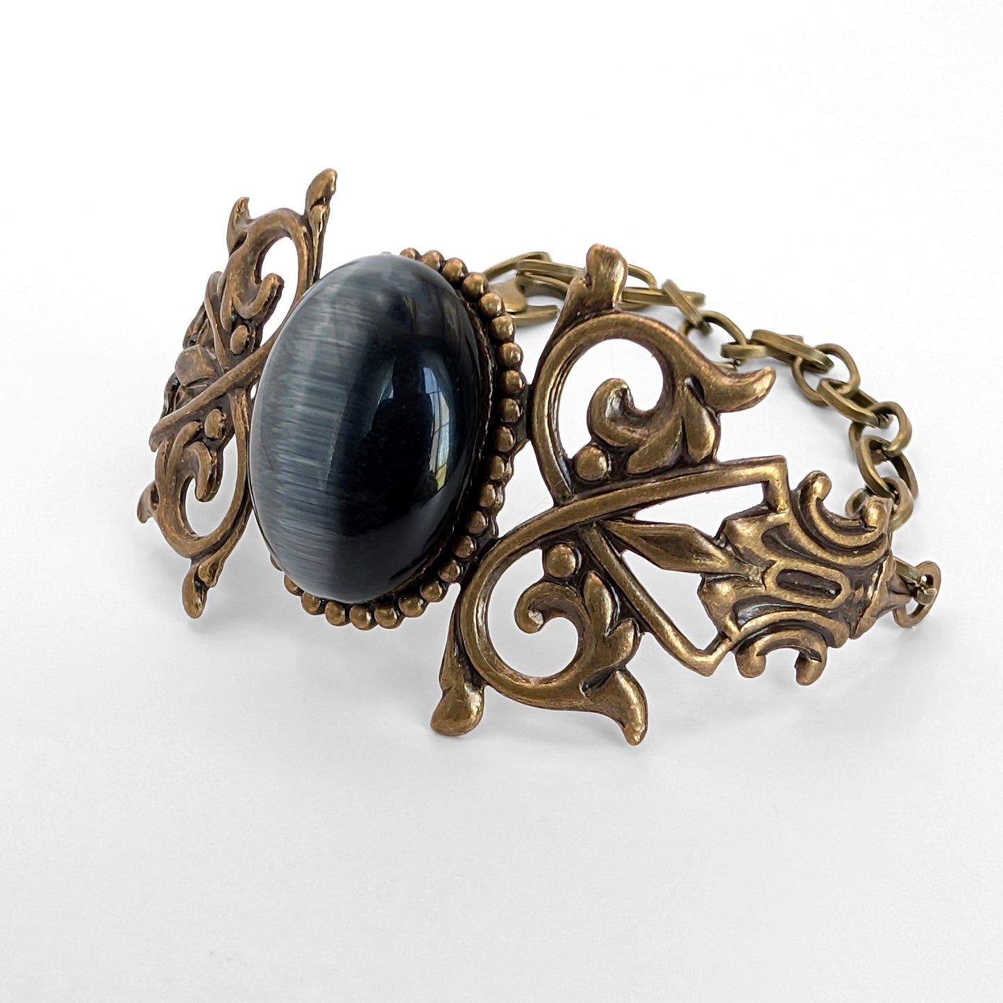 Black cats eye gothic brass bracelet, inside lighting