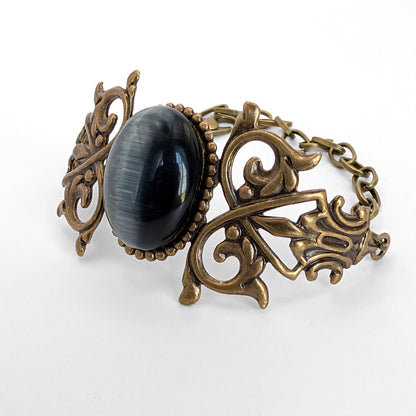 Black cats eye gothic brass bracelet, inside lighting