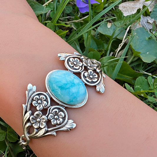 Larimar Stone Bracelet with Sterling Silver Floral Design on woman's wrist