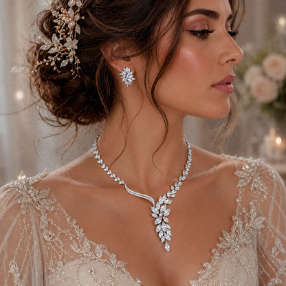 Woman wearing a sparkling cubic zirconia crystal bridal necklace and earring set with a blurred floral background