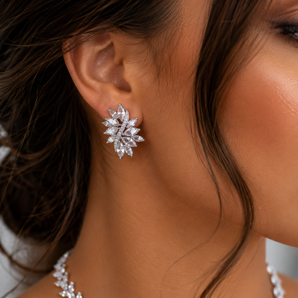 Close-up of a woman wearing a cubic zirconia silver earring.