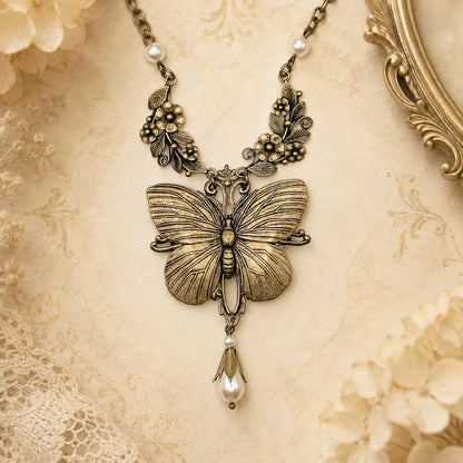 Brass butterfly pendant necklace with pearls and floral detail.  Fairycore Cottagecore jewelry