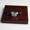 Butterfly-themed bracelet on a wooden box with a white background