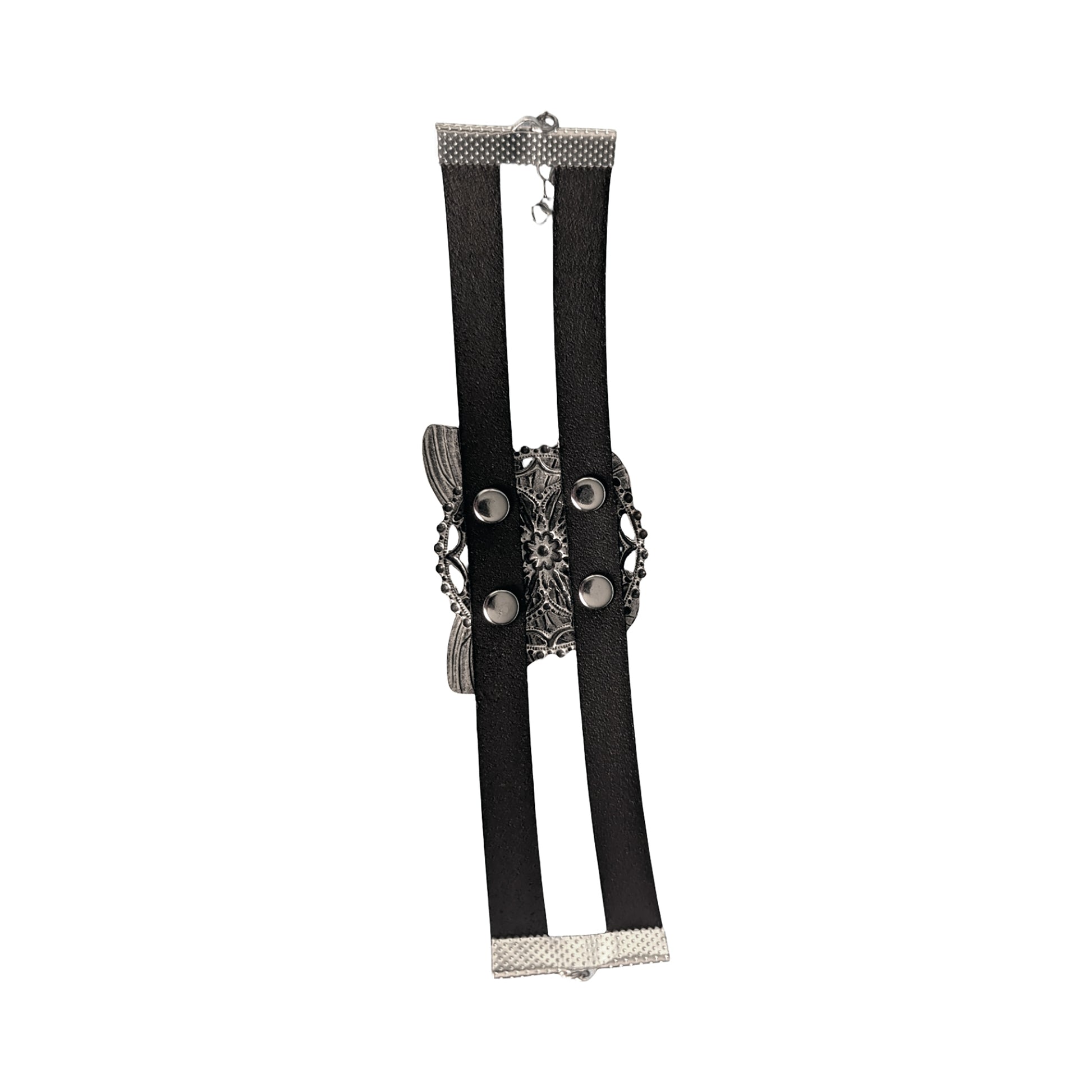 the back side of a silver butterfly bracelet, showing silver rivets and leather straps against a white background