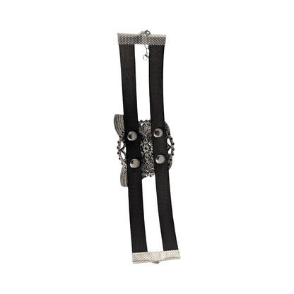 the back side of a silver butterfly bracelet, showing silver rivets and leather straps against a white background