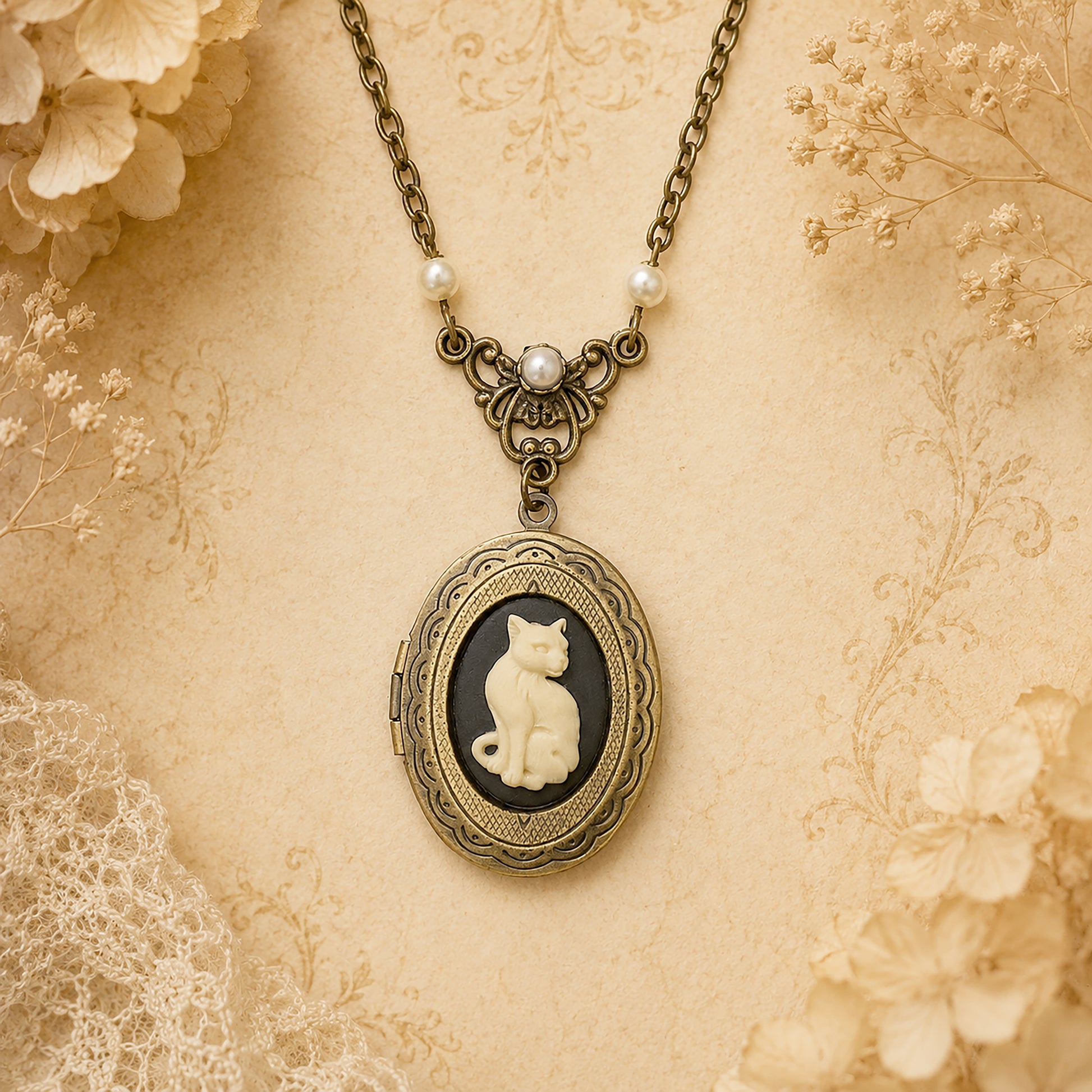 Vintage-style necklace with a cat cameo locket pendant on a floral background.  Cat lovers jewelry