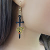 gold toned dragon on black sword on ear