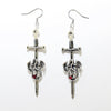 Silver sword and dragon earrings on a white background