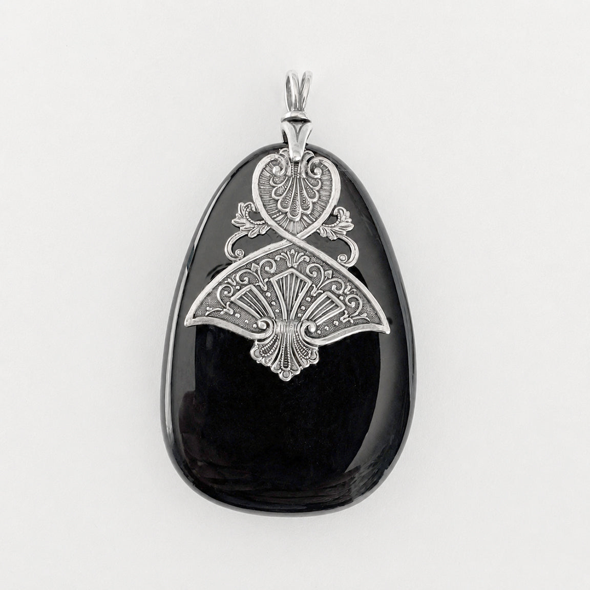 Black druzy stone pendant with silver decorative Art Dedco design on a white background.
