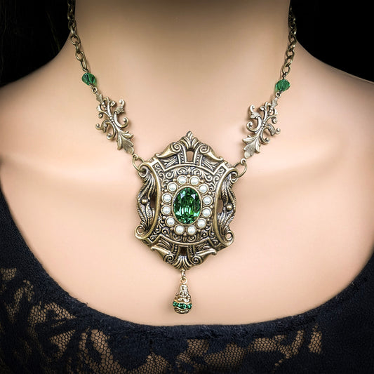 Ornate necklace with a green gemstone o