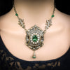 Ornate necklace with a green gemstone o