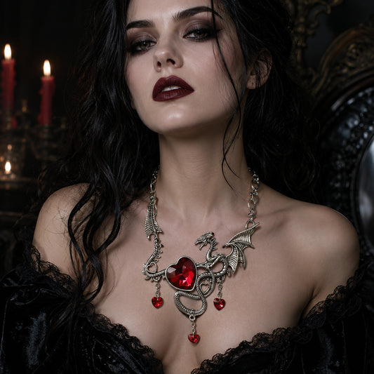 Gothic Woman wearing a dragon necklace with red heart rhinestones in a dark setting