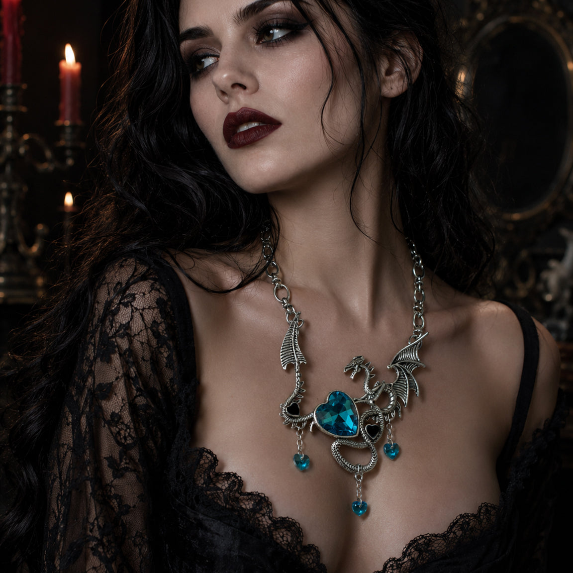 Gothic Woman wearing a detailed dragon  necklace with turquoise heart rhinestones in a dark, candlelit setting