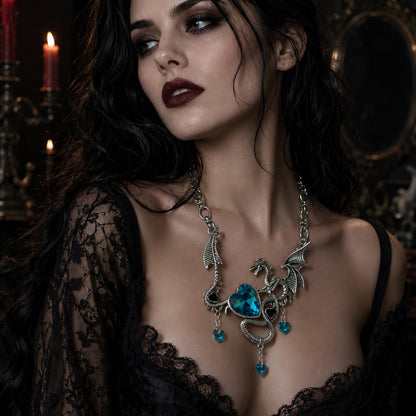 Gothic Woman wearing a detailed dragon  necklace with turquoise heart rhinestones in a dark, candlelit setting