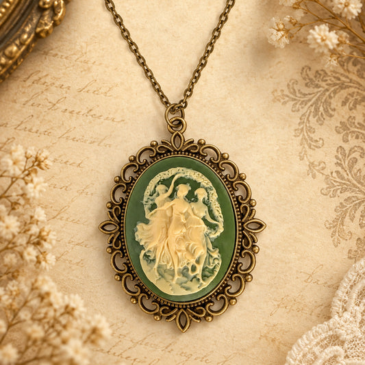 Greek three dancing muses green and cream cameo necklace on antique background.
