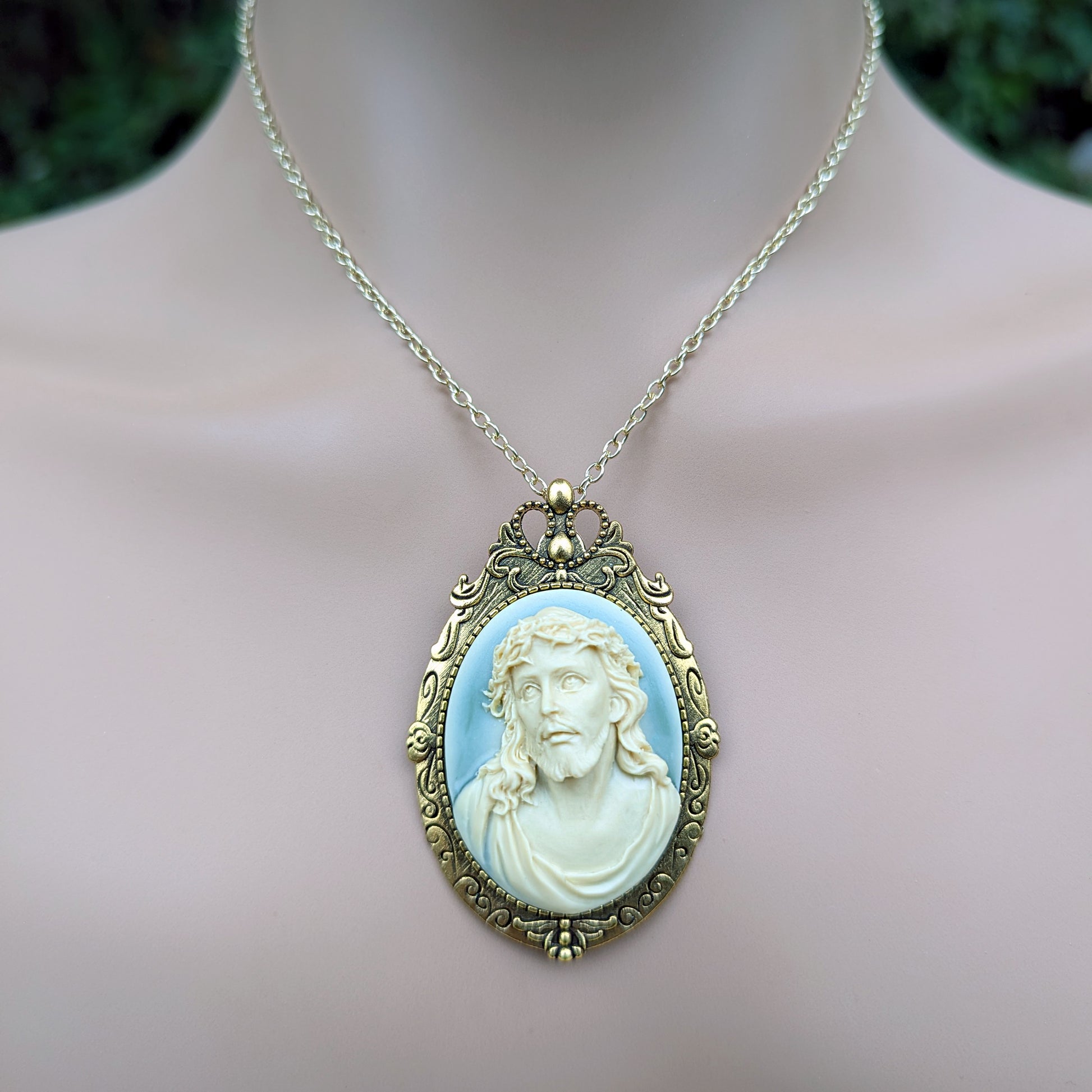 Necklace with a pendant featuring Jesus on a neutral background