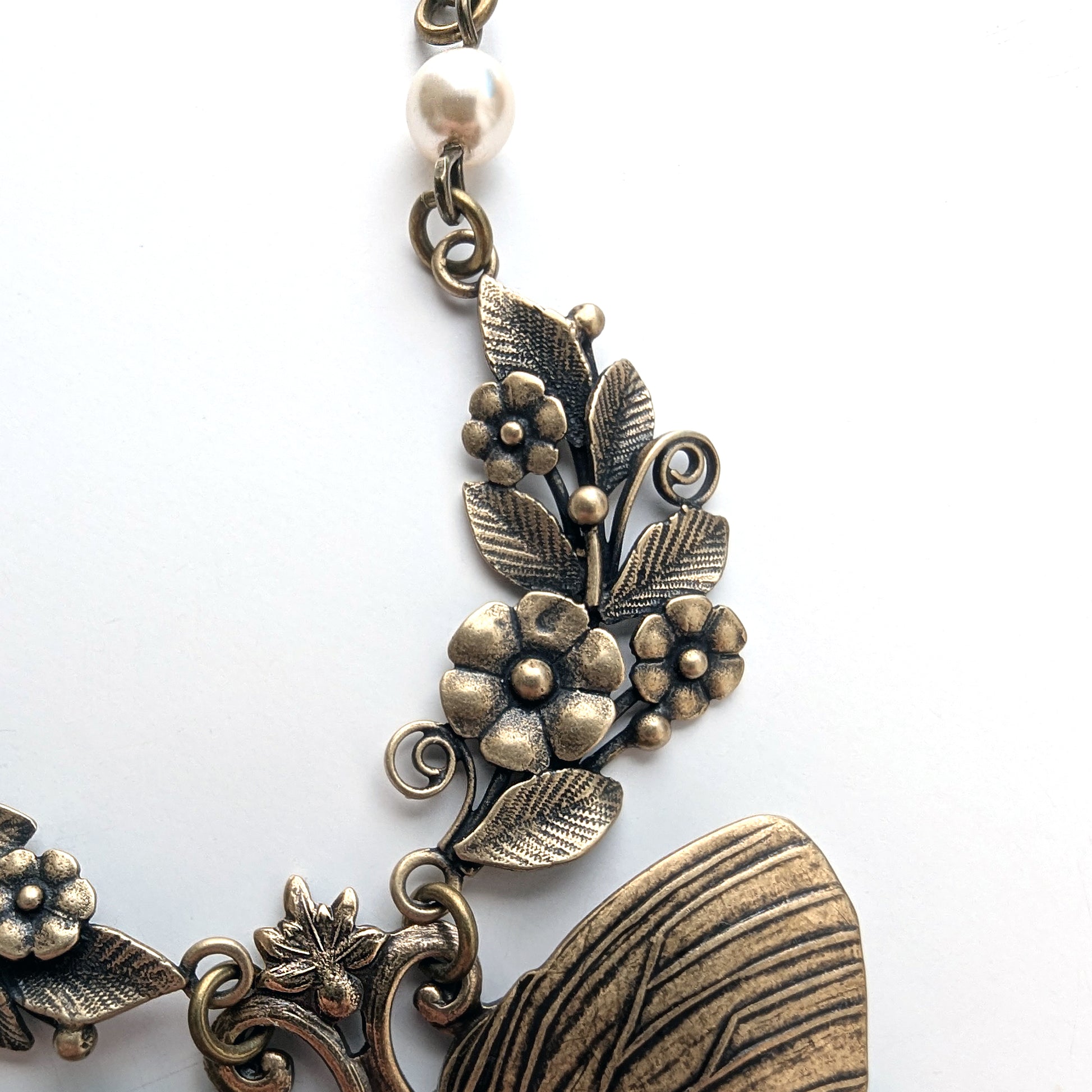 Bronze floral and leaf design on a white background