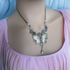 Vintage Whimsical Butterfly necklace pendant on a model with a pink top