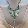 Butterfly necklace with floral elements on a model