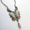 Bronze butterfly necklace on a white background