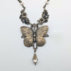 Vintage Butterfly pendant necklace with floral elements on a white background