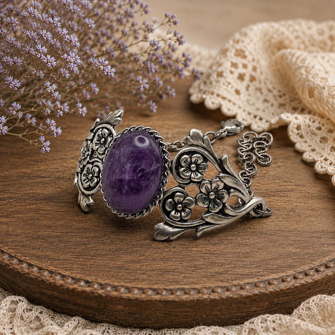 Silver bracelet with a purple gemstone on a wooden surface with lace and flowers.   Vintage Amethyst Bracelet with Floral Detail.  Art Nouveau Sterling Silver Jewelry