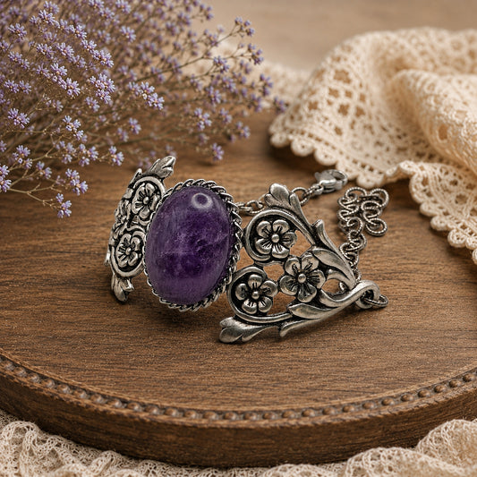 Silver bracelet with a purple gemstone on a wooden surface with lace and flowers.   Vintage Amethyst Bracelet with Floral Detail.  Art Nouveau Sterling Silver Jewelry