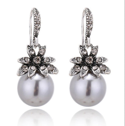 silver pearl drop earrings with rhinestone flowers with white background
