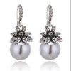 silver pearl drop earrings with rhinestone flowers with white background