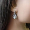 silver pearl drop earrings with rhinestone flowers on mannequin ear