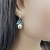 gold pearl drop earrings with rhinestone flowers on mannequin ear