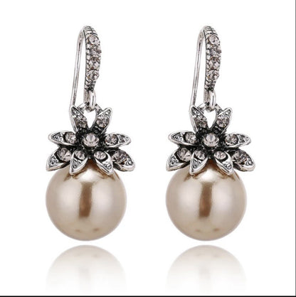 gold pearl drop earrings with rhinestone flowers with white background
