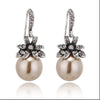 gold pearl drop earrings with rhinestone flowers with white background