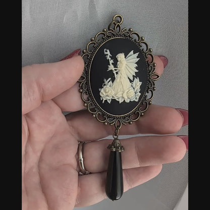 Vintage Fairy princess cameo pendant with black onyx drop bead held in hand.  Fairycore fantasy jewelry