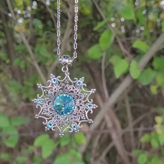 Sterling Silver Snowflake necklace and earring set made with aquamarine Swarovski crystals.