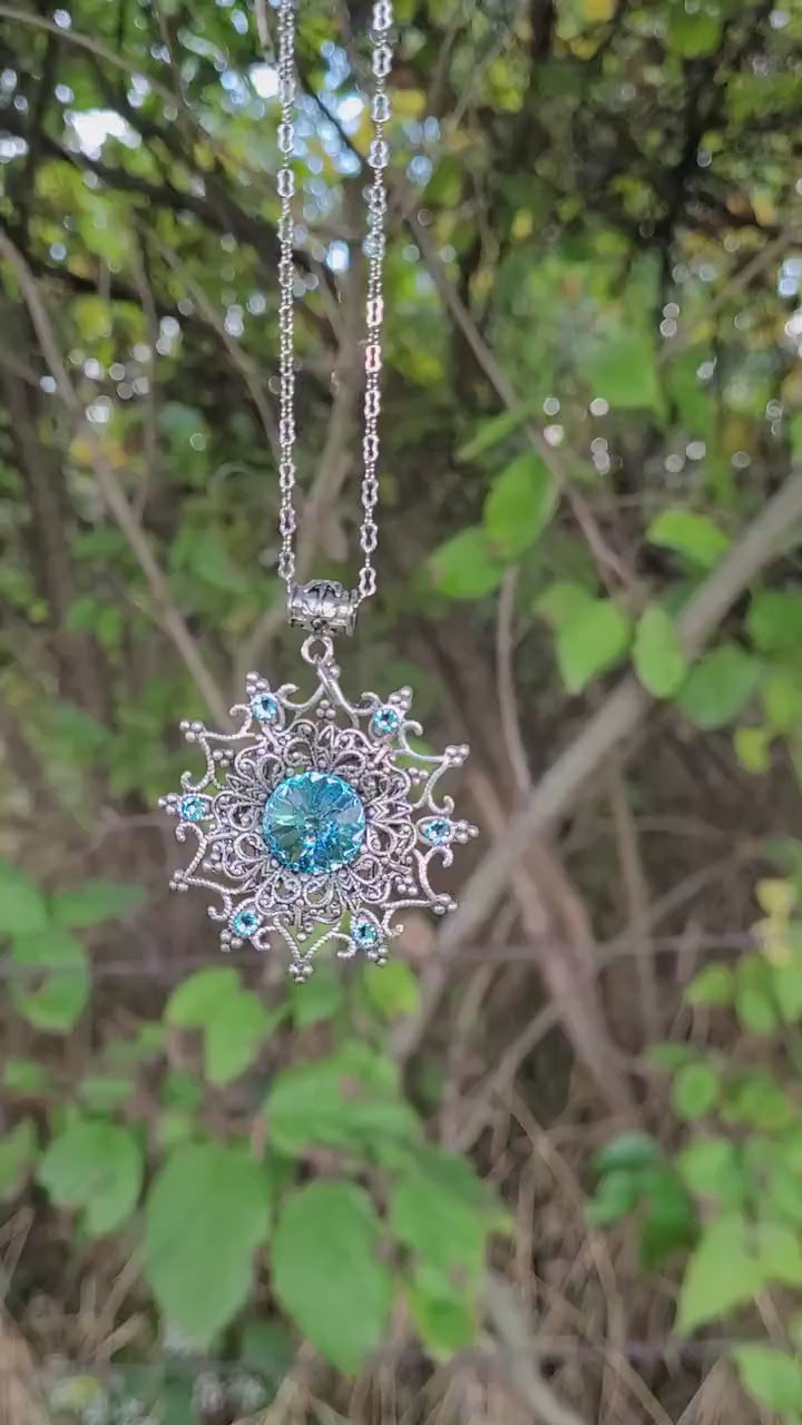 Sterling Silver Snowflake necklace and earring set made with aquamarine Swarovski crystals.